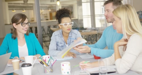Diverse Team Collaborating on Project in Bright Office