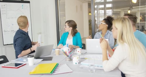 Team Brainstorming Business Strategy in Modern Office