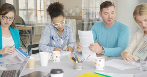 Business Team Works at Table Together in Office