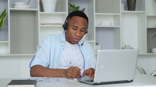 Young Adult Working Online From Home in Office
