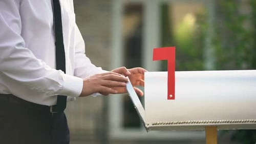 Man Putting Letters in Mailbox