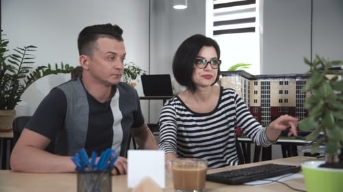 Man and Woman Collaborating in a Modern Office