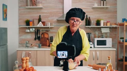 Woman Mixing Dough in Kitchen Recording Video
