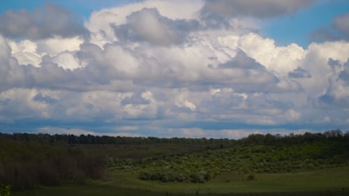 Dramatic Clouds Over Lush Rolling Hills