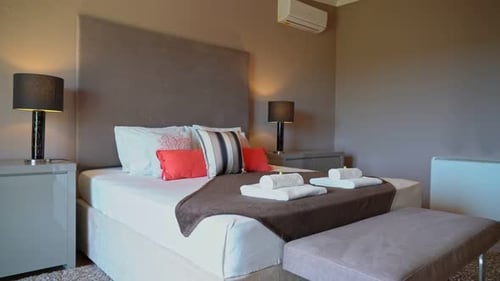 Zoom avant sur les oreillers placés sur le lit dans une chambre moderne naturellement bien éclairée et bien rangée