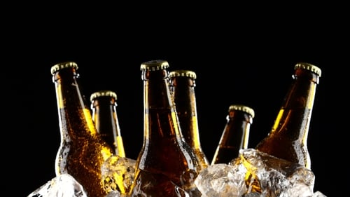 Chilled Brown Bottles in Ice on Black