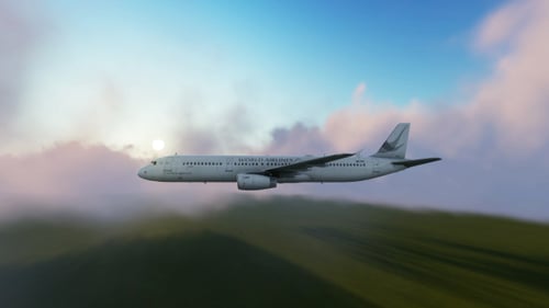 Commercial Airplane Flying Through Clouds and Sky