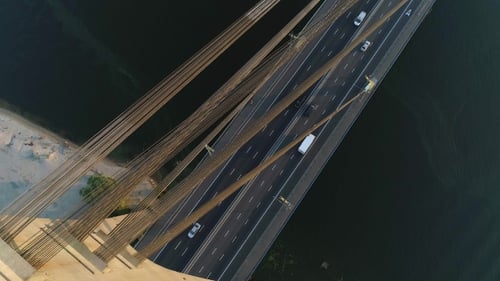 Aerial Drone Footage. Fly Over Moskovsky Bridge Pylon. View Road with Cars. At Sunset