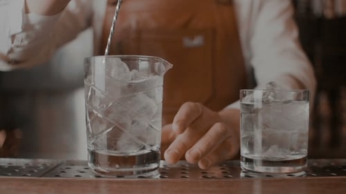 Bartender Mixing Ice in Glass