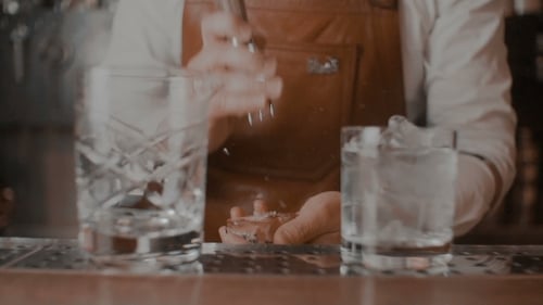 Bartender Preparing Ice for Drink at Bar