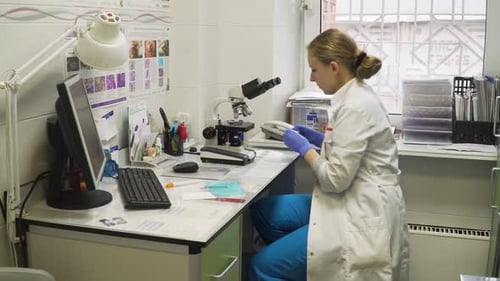 Scientist Prepares Sample for Microscope in Bright Lab