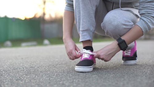 Woman Tying Shoe Laces Before Fitness Training