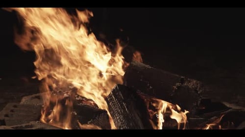 Blazing Fire in a Dark Firepit at Night