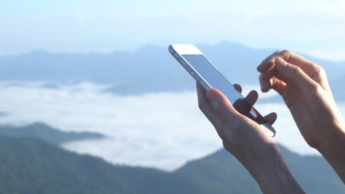 Hands using Smartphone with Mountain View