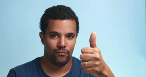 Man Shows Various Expressions Against Blue Background