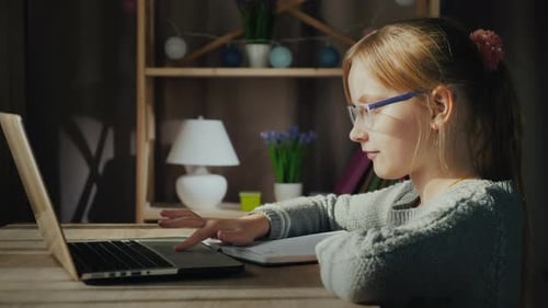 Girl Uses Laptop for School at Home