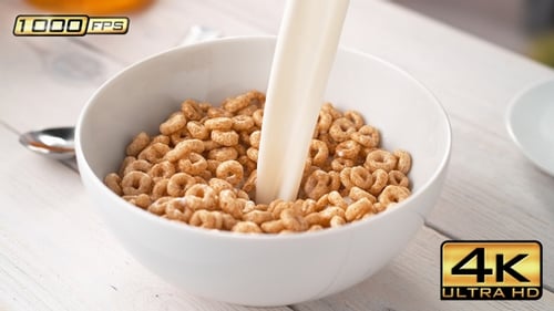 Pouring Milk into Bowl of Circle-Shaped Cereals