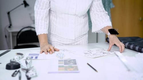Fashion Designer Sketching Designs in Studio