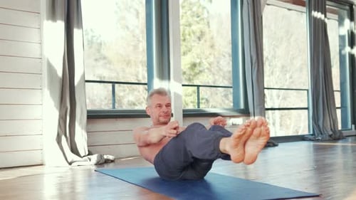 Shirtless Man Practicing Yoga Poses Indoors