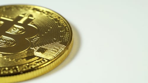 Close-up of Gold Bitcoin Coin on White Surface