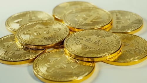 Gold Bitcoin Coins Piled on White Surface