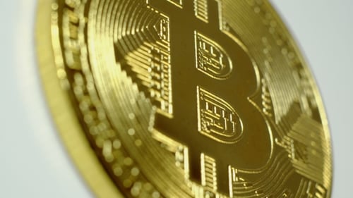 Close Up of Golden Bitcoin Rotating on White