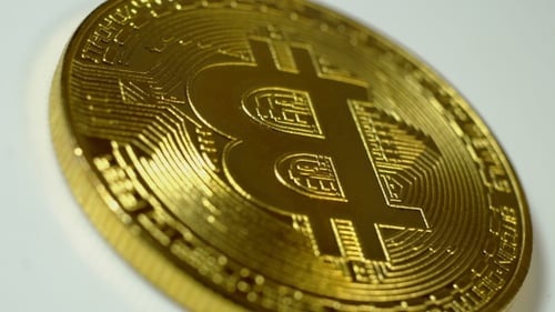 Golden Bitcoin Spinning in Close Up Detail