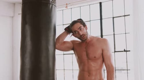 Sweaty Man with Boxing Gloves Wipes Sweat