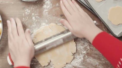 Rolling Flat Cookie Dough on Wood Table