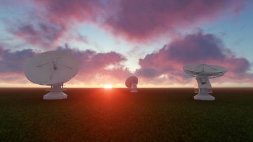 Satellite Dishes Rotating Against a Sunset Sky