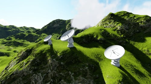 Satellite Dishes on Green Mountains Above Clouds