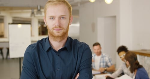 Man Posing in Office with Coworkers
