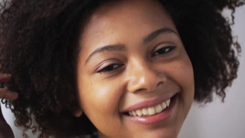 Smiling Young Adult Woman with Curly Hair