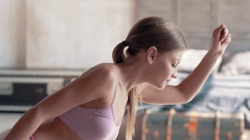 Woman Doing a Side Plank Exercise Indoors
