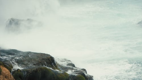 Splashes of the Waterfall Falling on Rocks