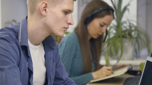 Busy Hands Typing at Desks in Office
