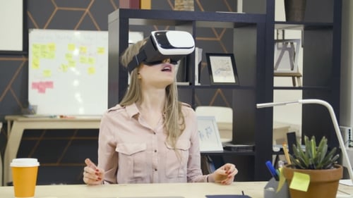 Woman Using VR Headset in Modern Office