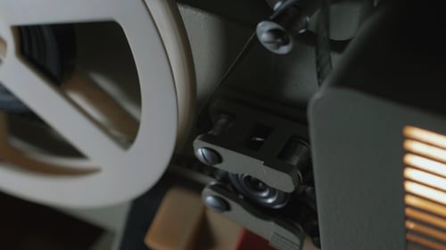 Film Projector on a Black Background with Dramatic Lighting and Selective Focus. Retro Film