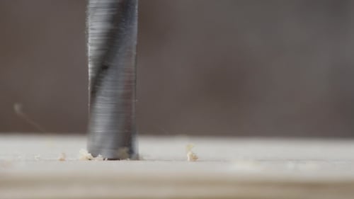 Drill Bit Bores into Wood Close Up