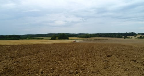 Agricultural Tractor Plowing Field