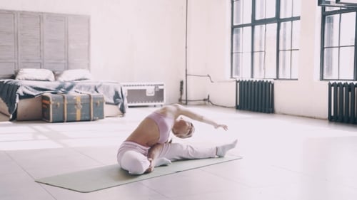 Woman Stretching on Yoga Mat Indoors