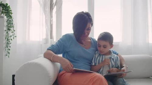 Mother and Child Reading on Tablets Together