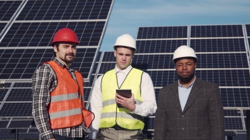 Engineers Standing in Front of Solar Panels