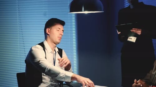 Middle Close-up of Police Detective Throwing Evidence of Crime on the Table in Interrogation Room