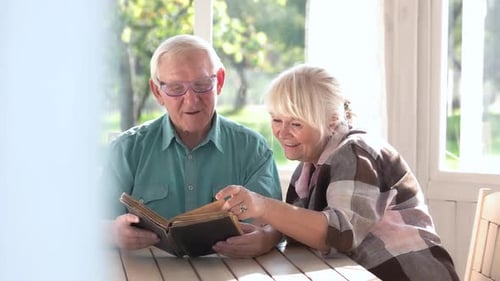 Elderly Couple Reading a Book.