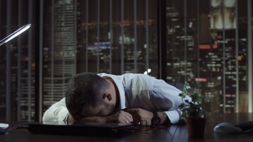 Exhausted Man Sleeping in Office
