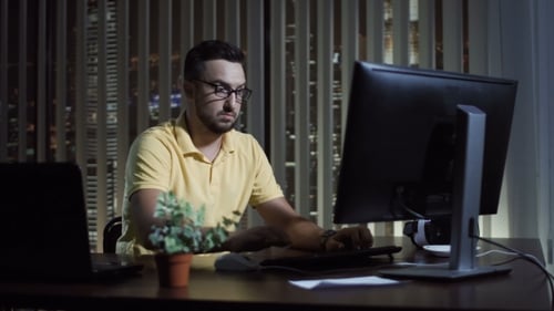 Man Working in Office at Night