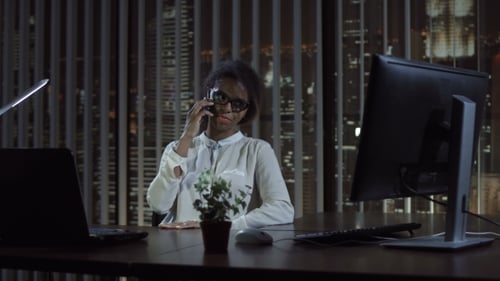 Black Woman Talking Phone in Office