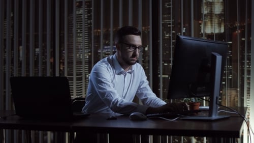 Thoughtful Office Worker at Computer