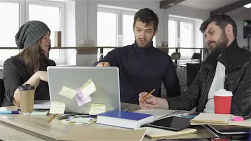 Team of Young Professionals Having a Meeting in a Creative Office. Team Leader Explaining the Task